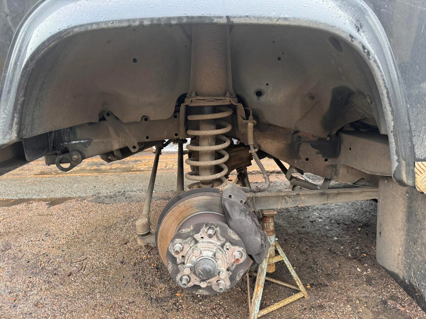 Underbody before treatment — road grime and surface corrosion